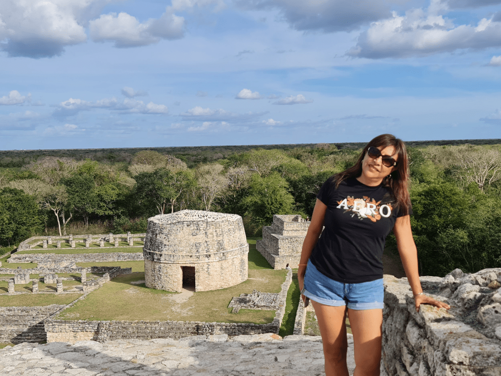 Woman on top of a pyramid at Ek Balam archeological site in Yucatan Mexico