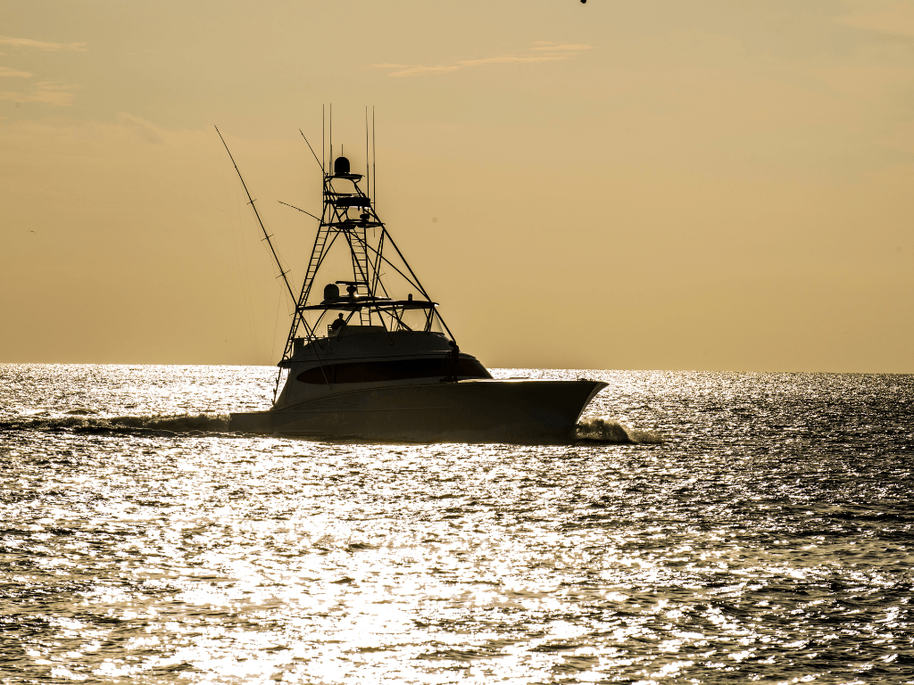 charter boat on the ocean at sunset