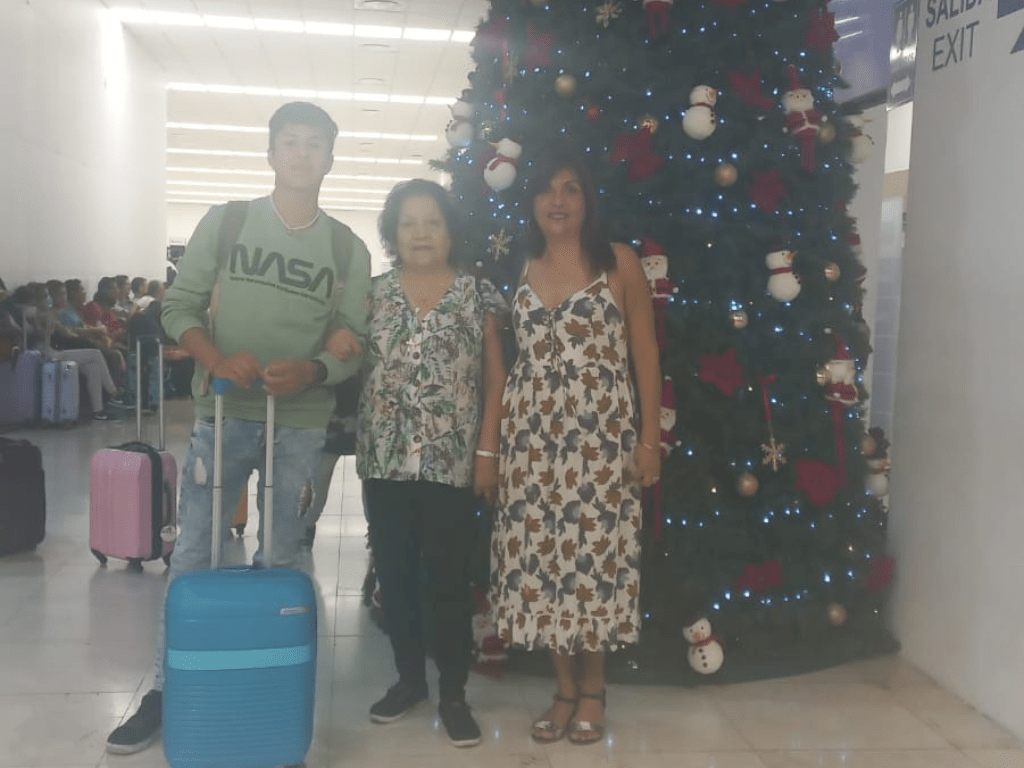 inside Merida airport in front of a christmas tree