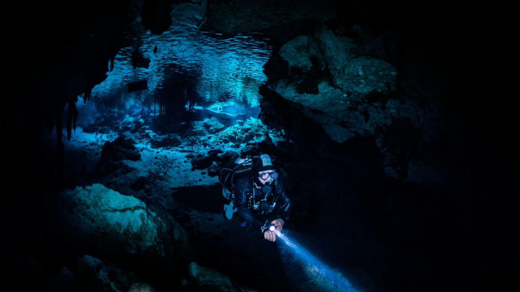 scuba diving in a dark cenote